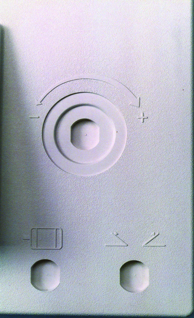 close-up photo of a pressure formed part showing embossed markings