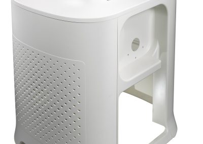 Angled view of a partially assembled pressure formed enclosure for cancer treatment system cart