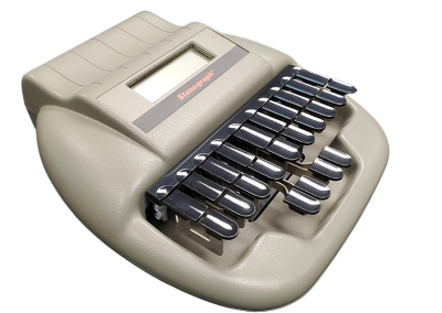 Beige stenography machine enclosure with a small display window and rows of black key levers on top. The device is shown at an angle against a plain background.